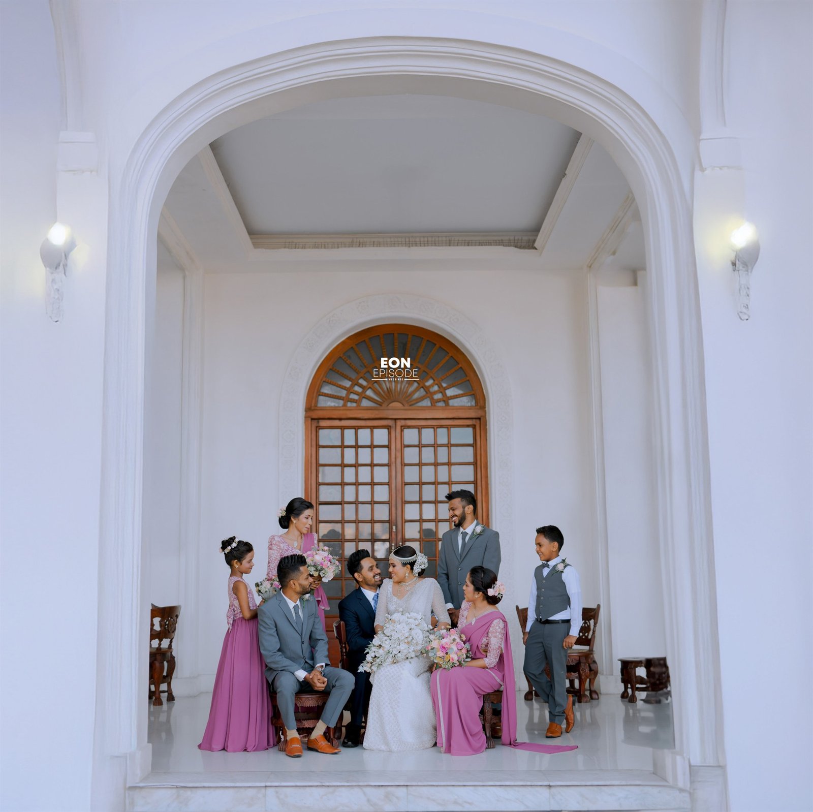 Amandi and Dineth surrounded by family after their wedding ceremony