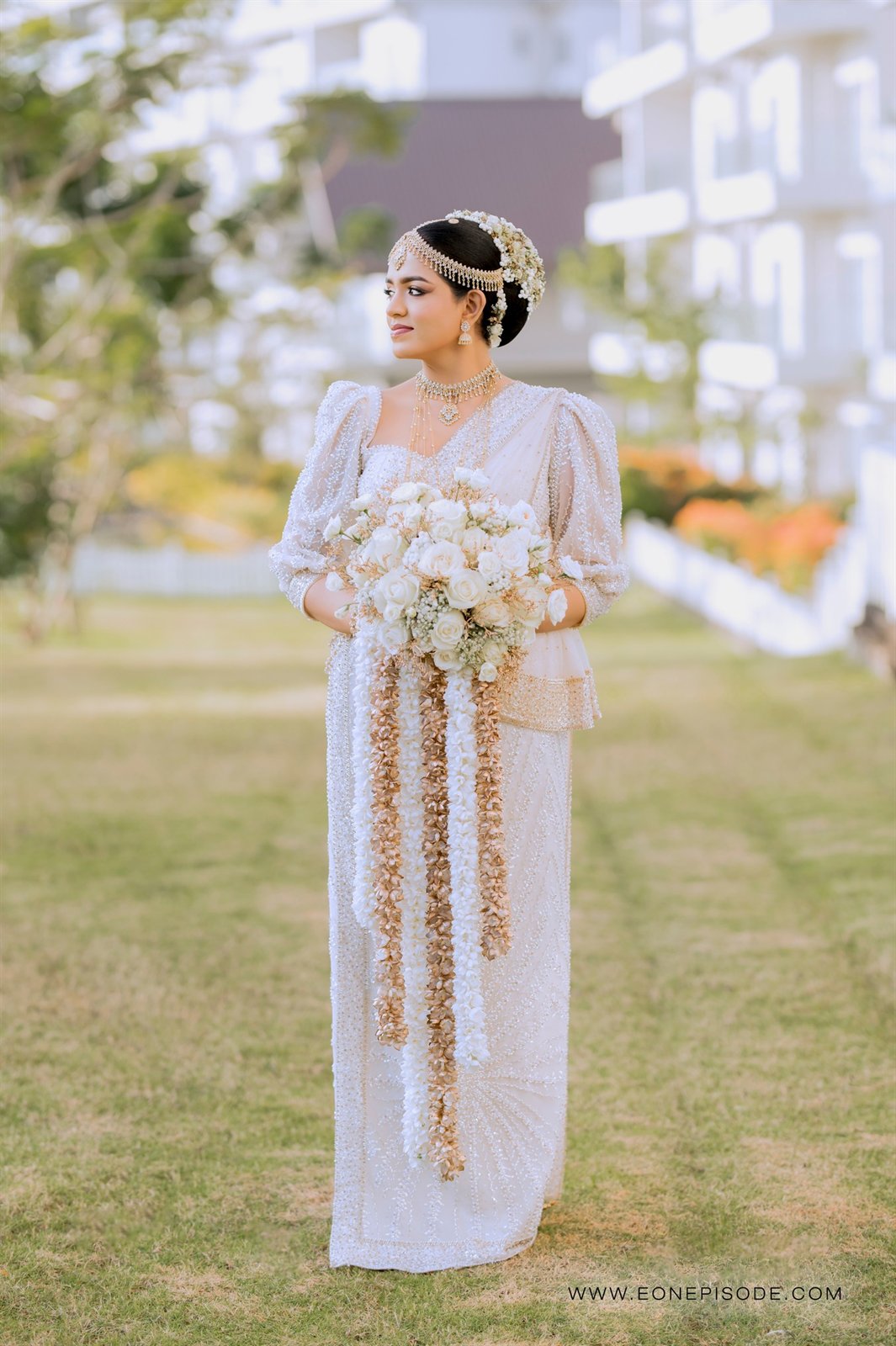 Bhawana in her wedding dress holding a bouquet